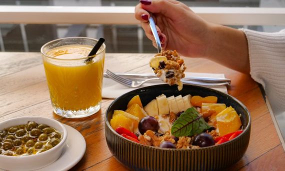 Enjoy a nutritious breakfast with fruit, nuts, and juice in a calm setting in İzmir, Türkiye.